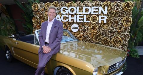 'The Golden Bachelor' leading man Gerry Turner dons a purple suit while leaning on a gold convertible at an event.
