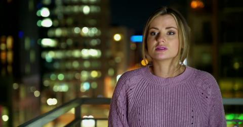 Clare talks to producers on a patio in Season 17 of MAFS