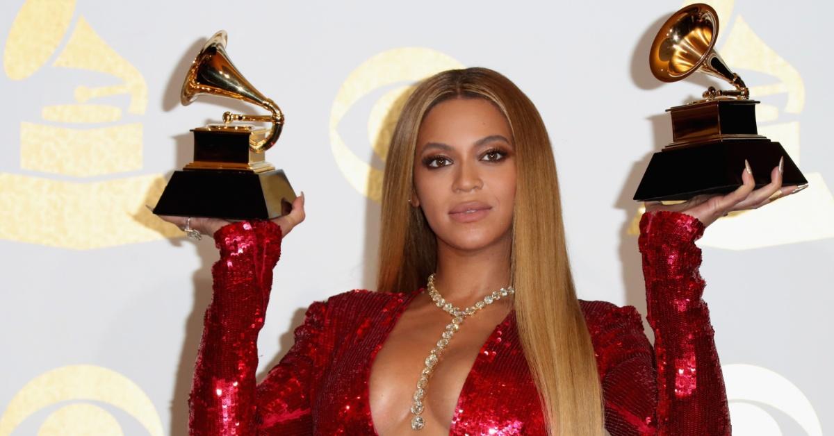 Beyoncé holding up two Grammy awards