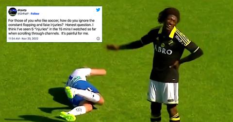 Soccer player fakes an injury.