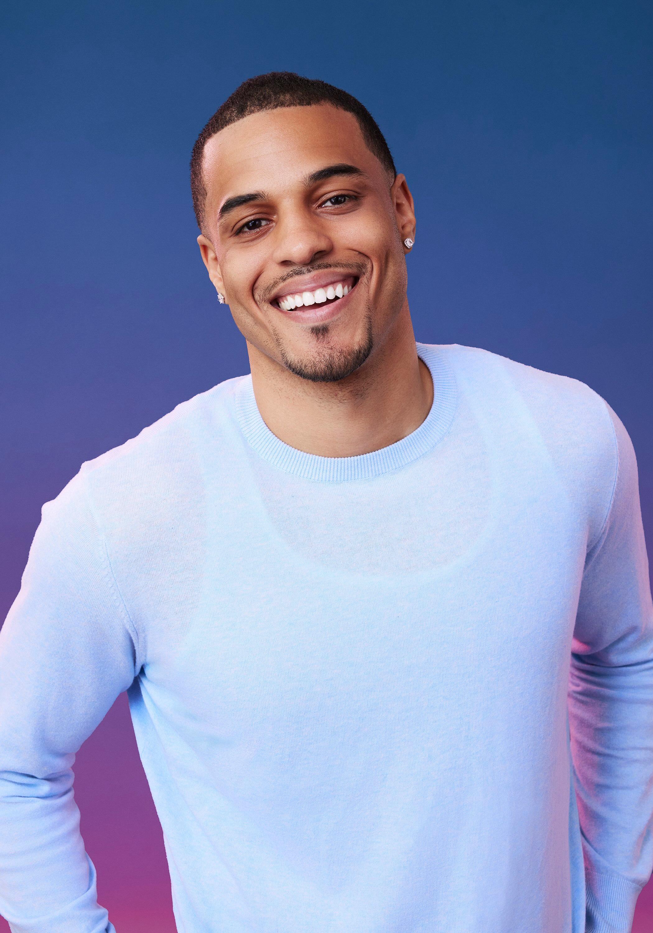 Grant poses in front of a blue-purple ombré background for his official 'The Bachelorette' Season 21 portrait.