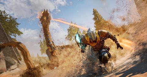 'Atlas Fallen' Player-character surfing on sand to avoid a worm enemy.