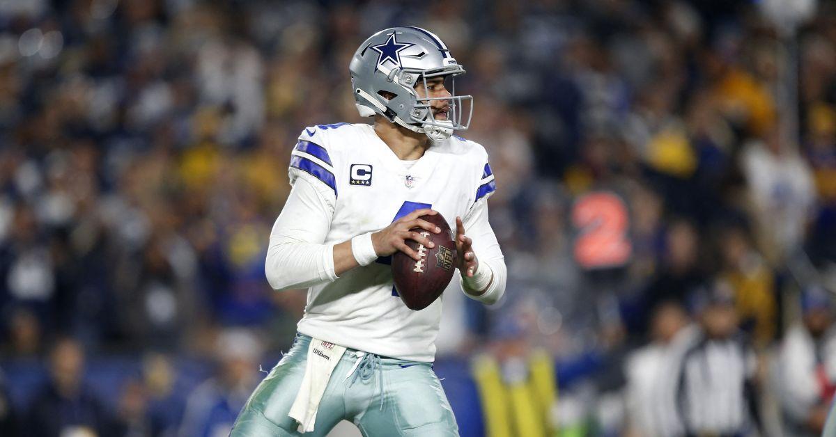 Dak Prescott playing in the NFL Playoffs in 2019 with the football.