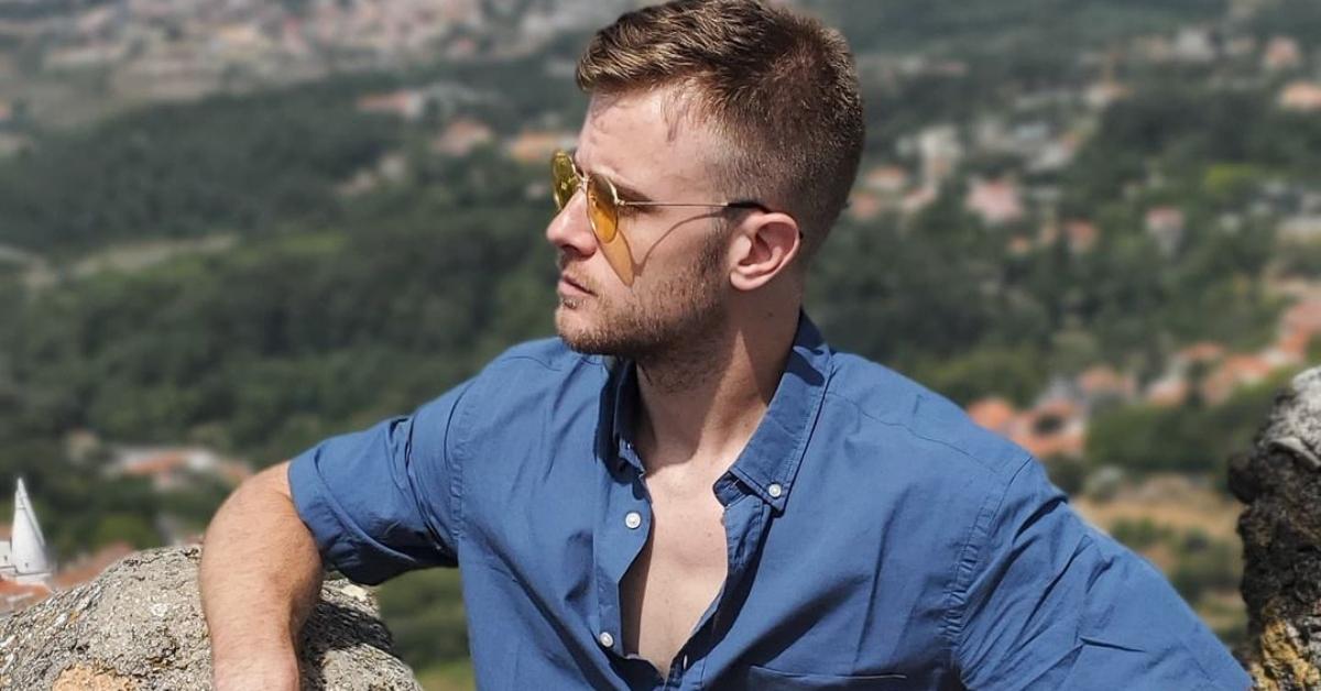 James Pierce from 'The Bachelorette' stands on a mountaintop in Portugal