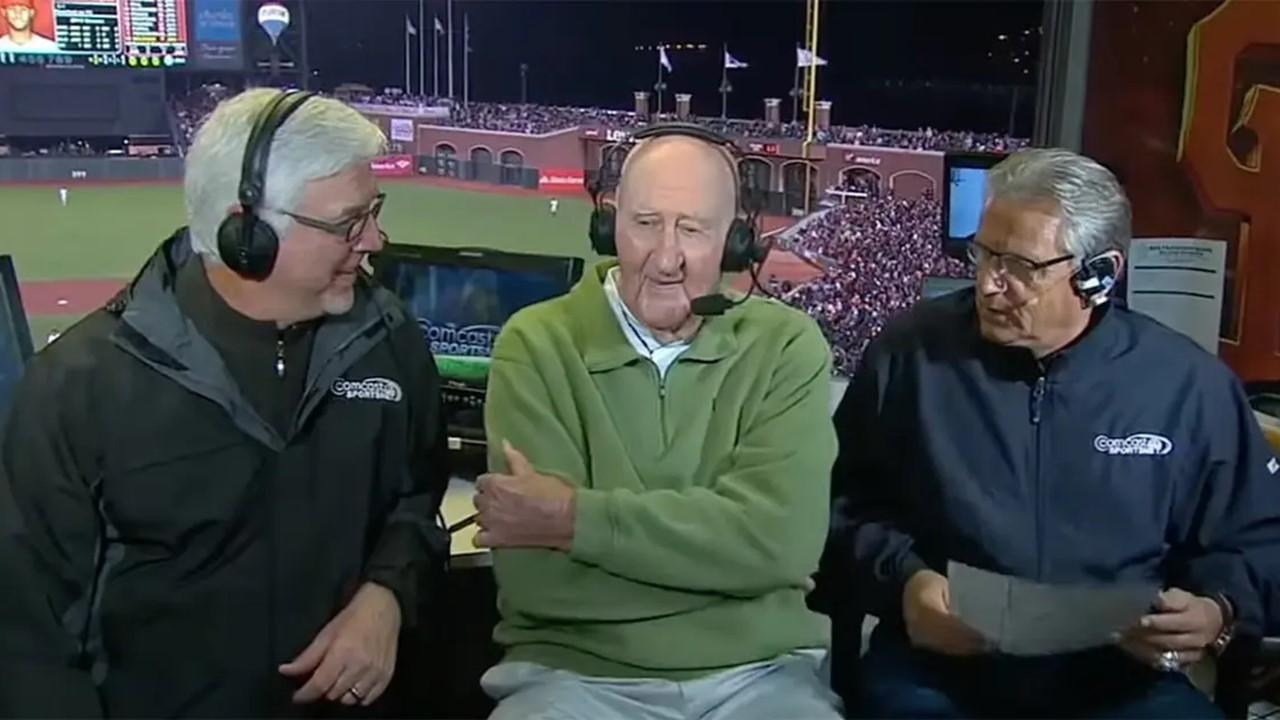 Roger Craig (center) in a broadcast booth in 2014
