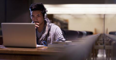 A man looking at Facebook's new logo on his laptop