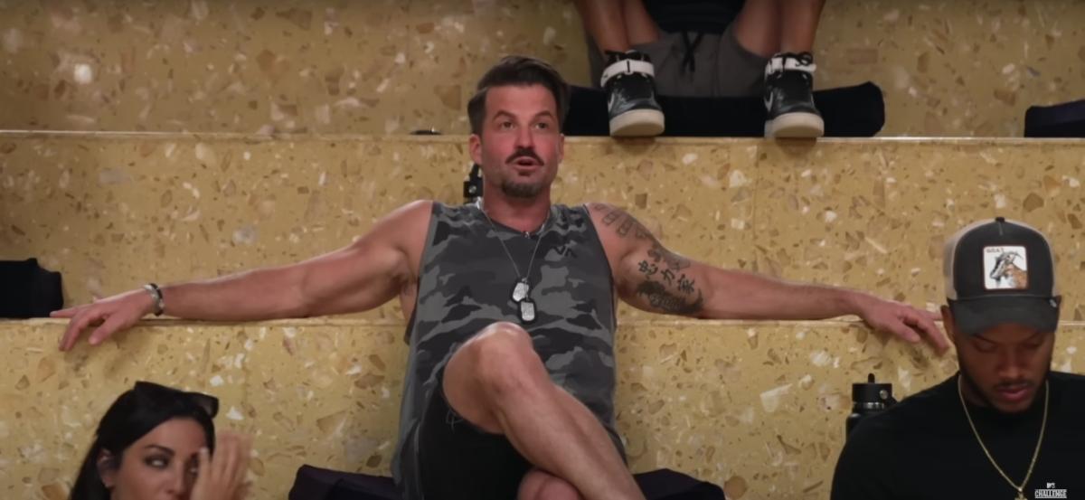 Johnny Bananas sits on the steps inside the castle on The Challenge