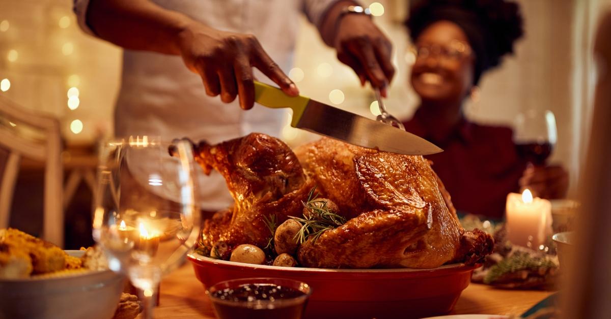 Man carving a Thanksgiving turkey