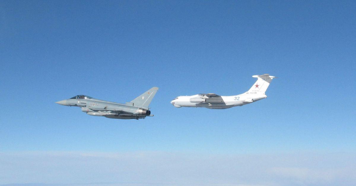 Two warplanes flying through the air.