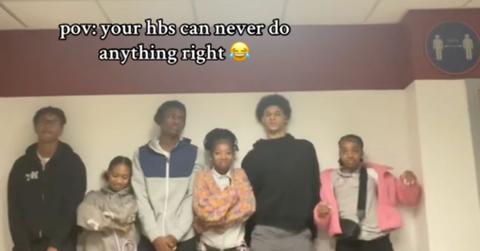 A group of friends posing for a TikTok video.