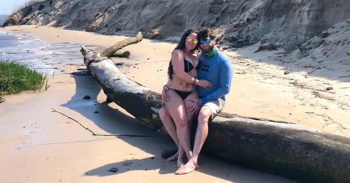 Jenelle Evans sits on David Eason's lap on a beach