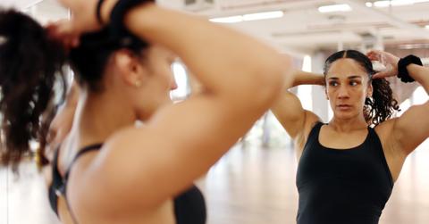 Amanda Serrano tying back her hair before training.