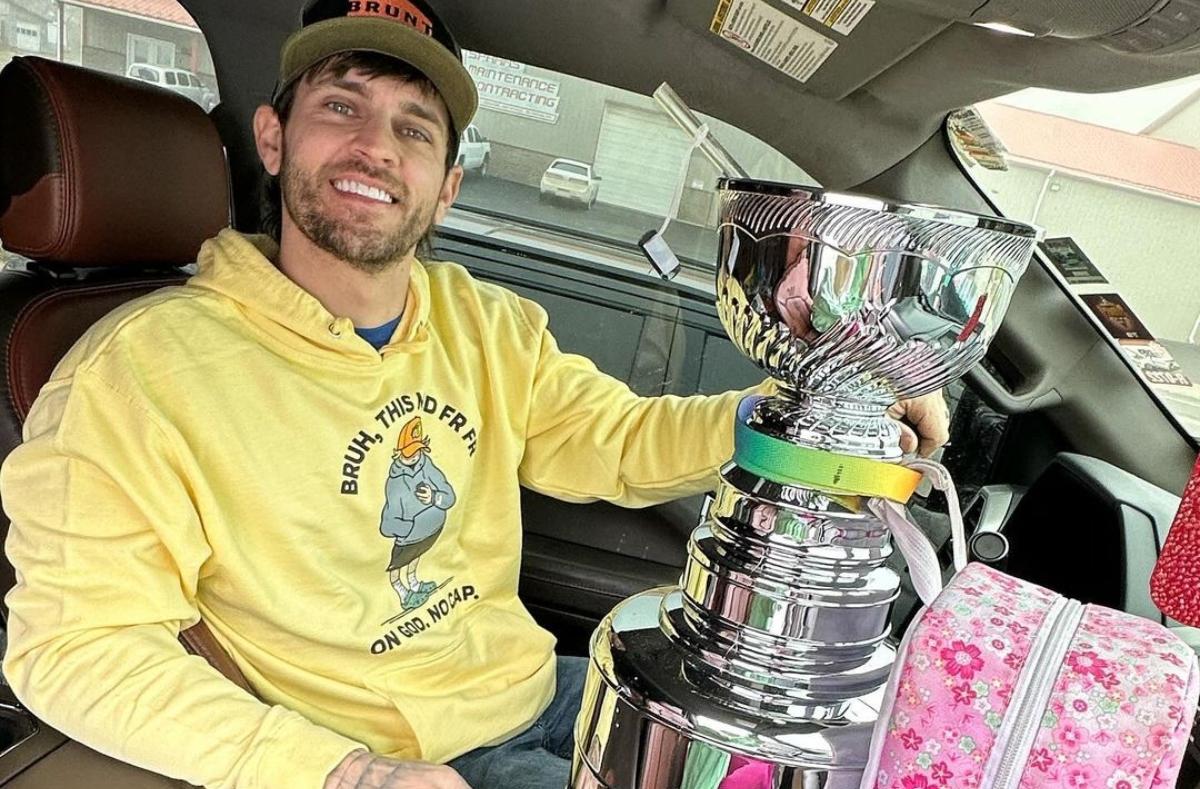 Bryce Sparks in his car with a trophy