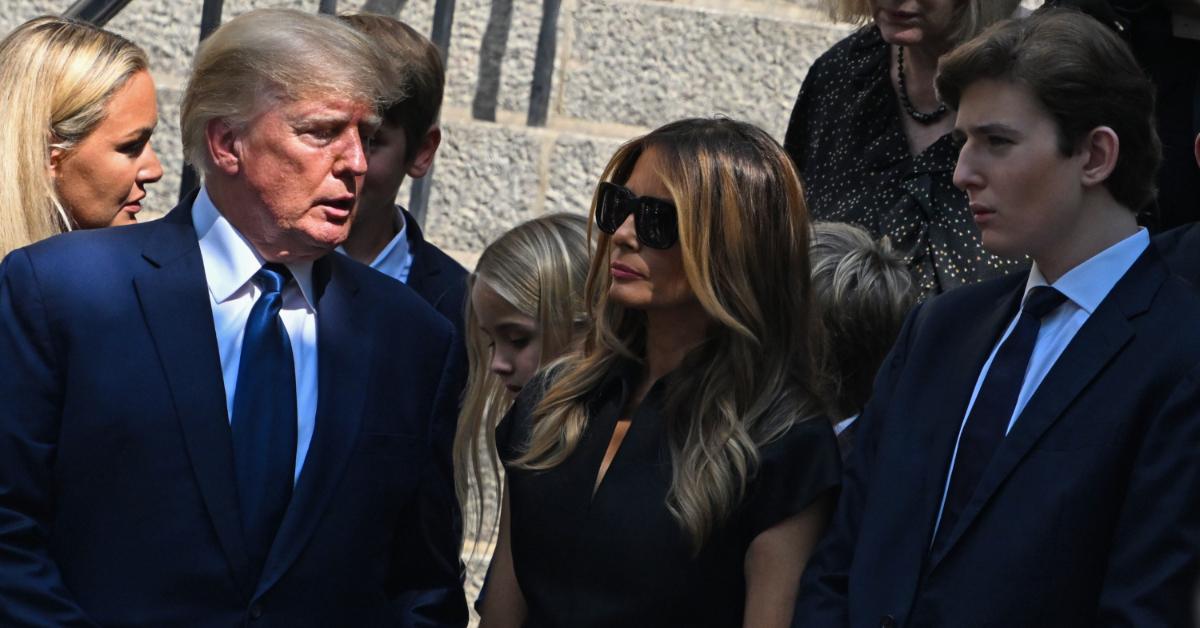 Donald, Melania, and Barron Trump posing for a photograph