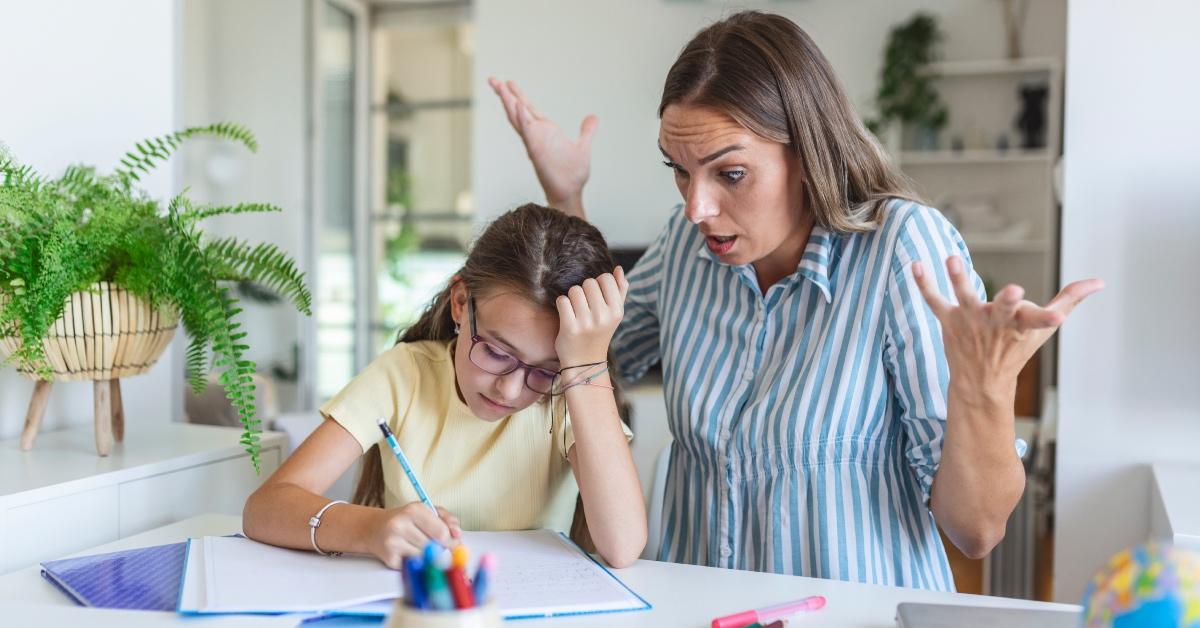 A frustrated parent trying to help their child with homework.