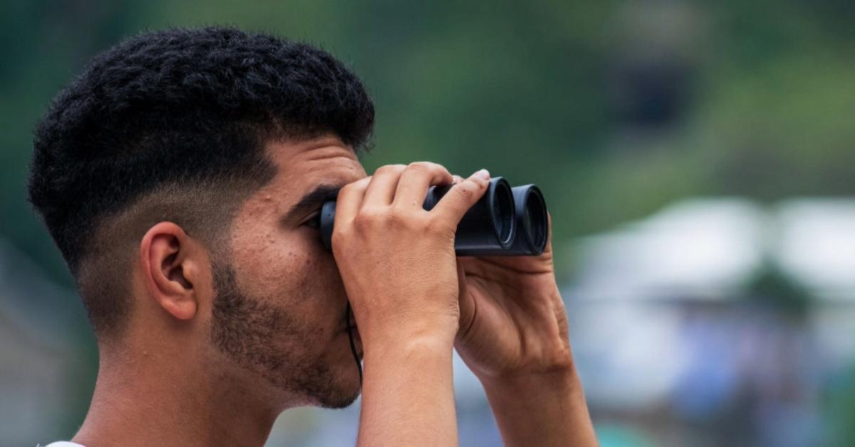 Man looking through binoculars