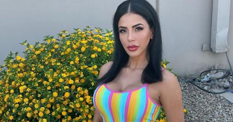 Jasmine Pineada in a striped dress in front of yellow flowers