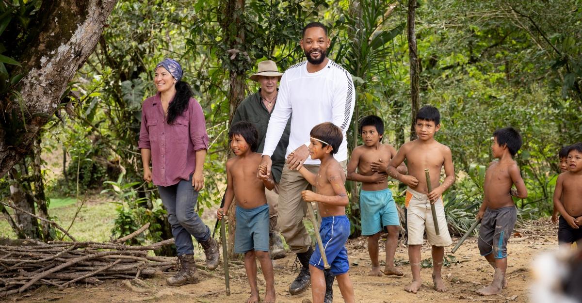Will Smith smiles as he holds hands with children in his travel series Pole to Pole.