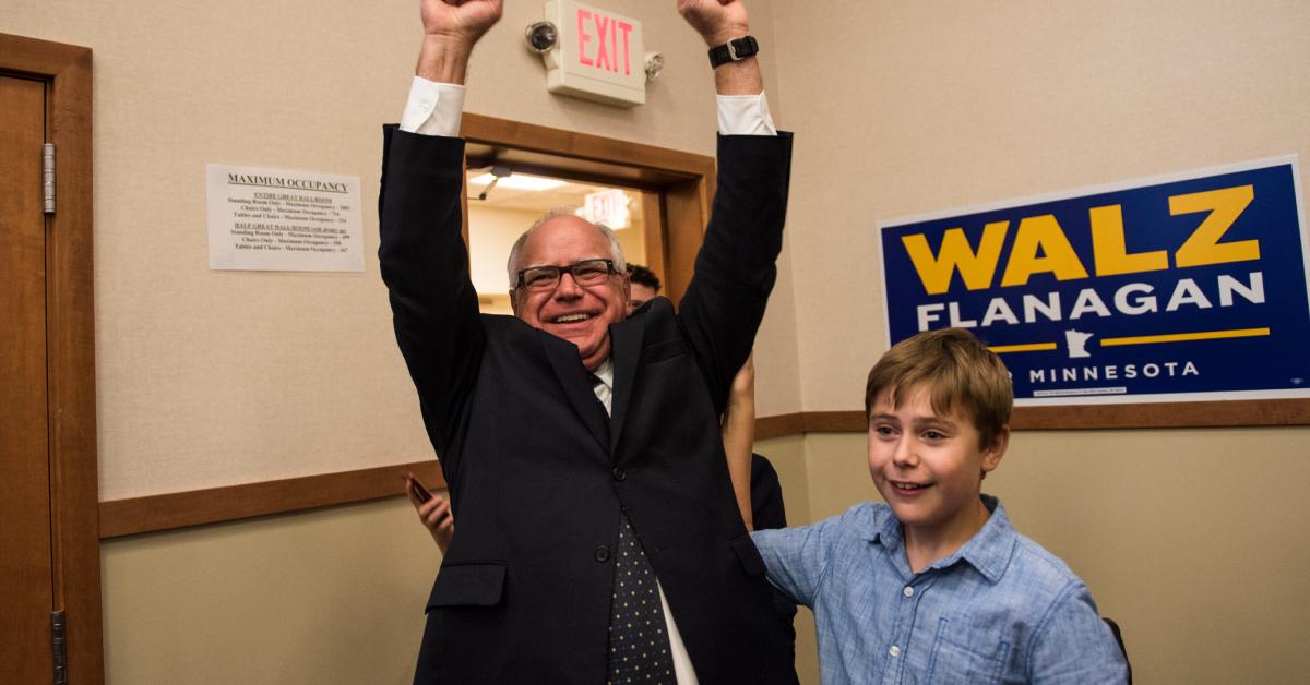 Tim Walz and his son, Gus, celebrate while entering his election night party on Aug. 14, 2018 in Saint Paul, Minn. 