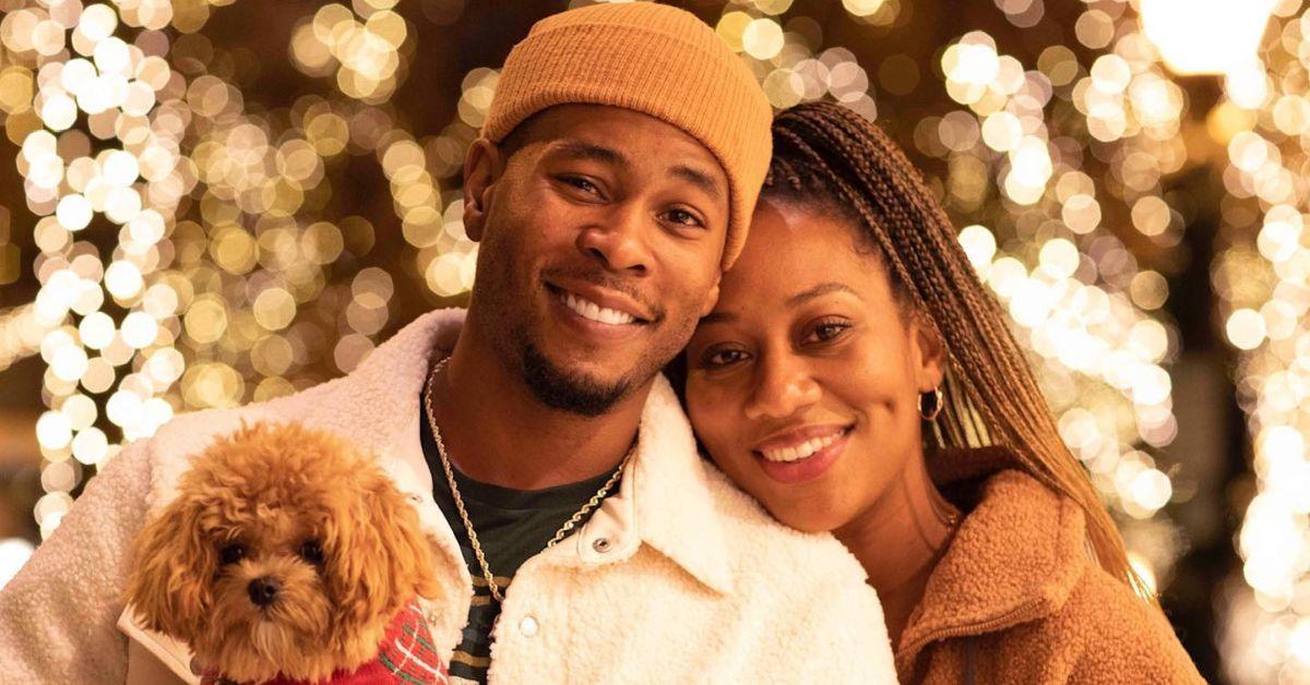 (l-r): J. Alphonse Nicholson and Nafeesha Nicholson posing with a dog for an Instagram photo. 