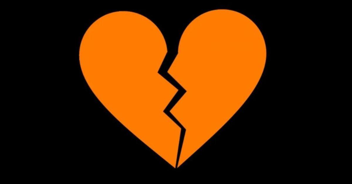 The orange broken heart emoji on a black background. 