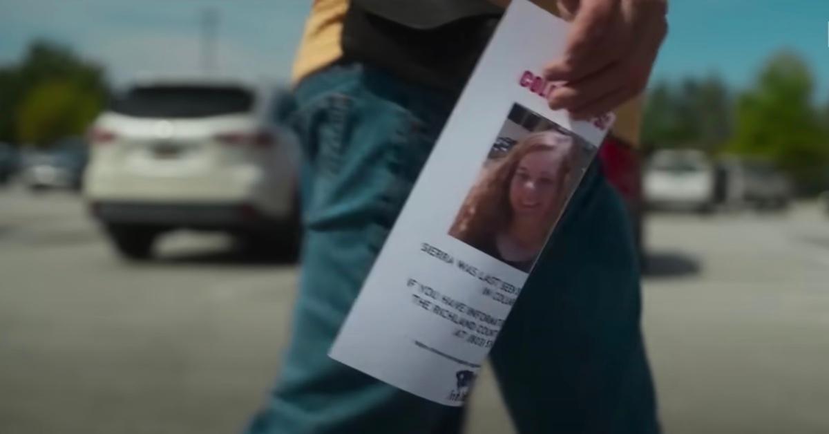 a person holds a missing persons flier of Sierra Stevens