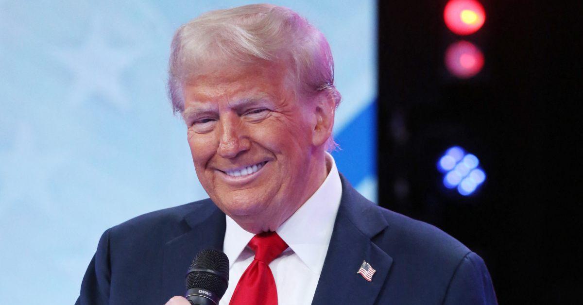 Donald Trump smiling at a political event.