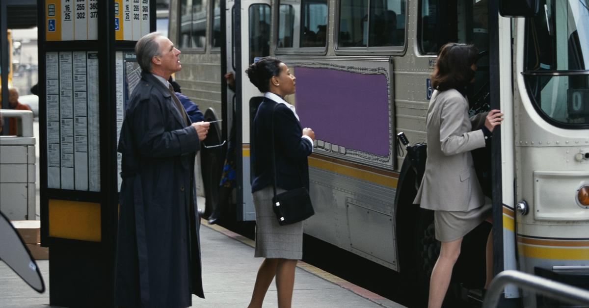 Businesspeople boarding a bus.