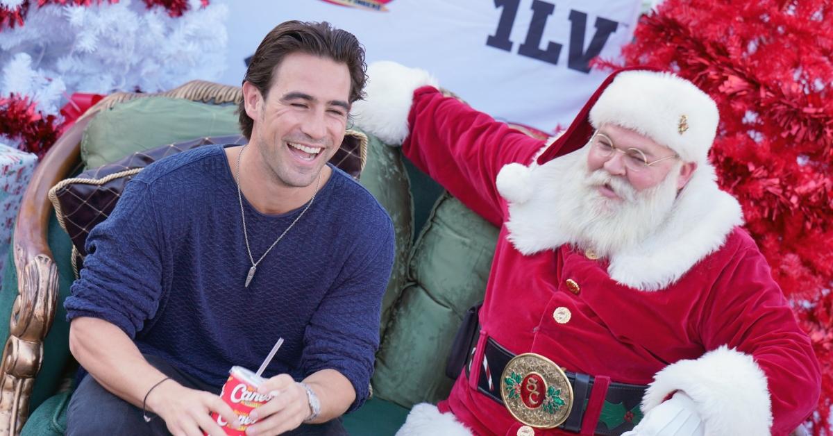(l-r): 'Vanderpump Rules' star Chris Hahn posing with Santa at Raising Cane's' bike giveaway event in Los Angeles, Calif