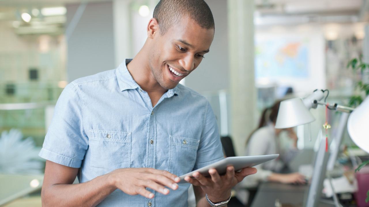 man reading on tablet