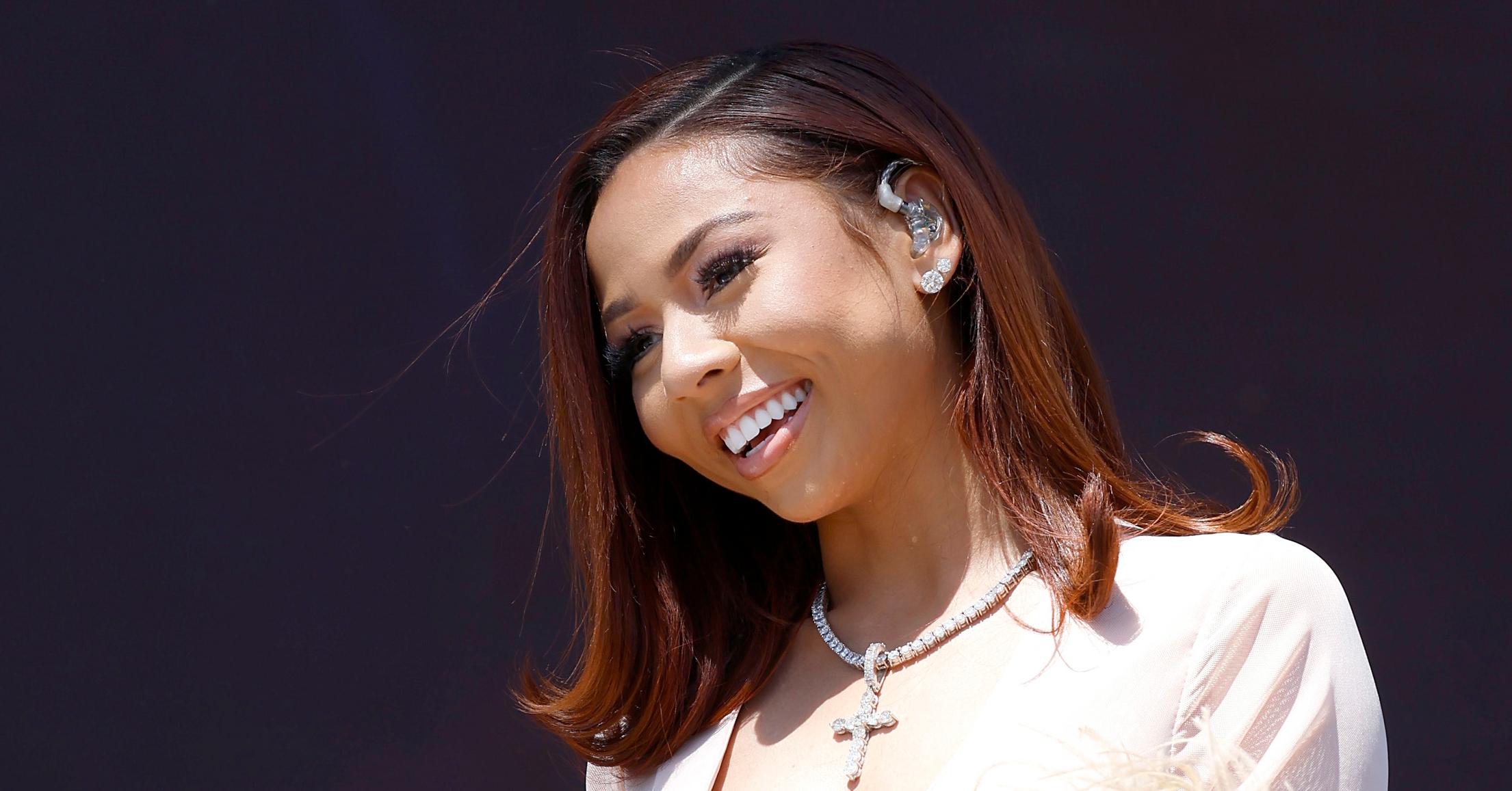 Mariah the Scientist smiles at fans on stage at Coachella.