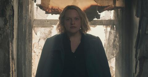 June sitting in the destroyed house where she served as a handmaid.