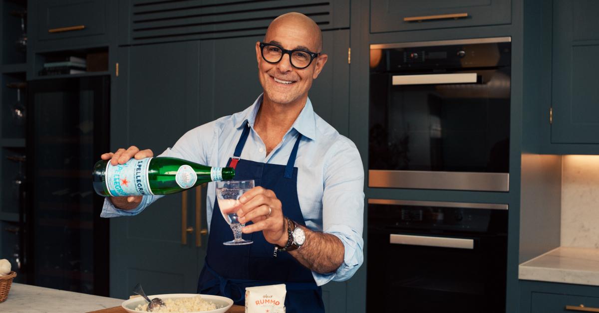 Photo of actor and filmmaker Stanley Tucci in a kitchen with his S.Pellegrino 2023 recipe kit