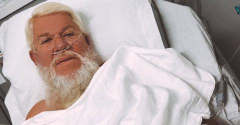 John Daly sitting in a hospital bed.
