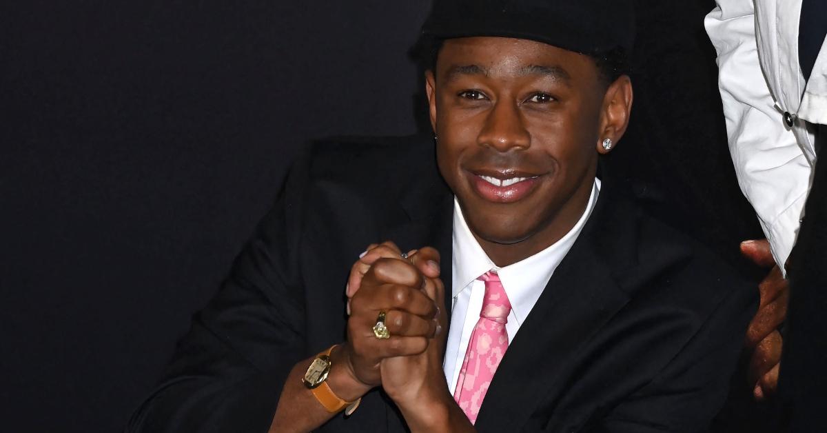 Tyler the creator wearing a suit and a pink tie