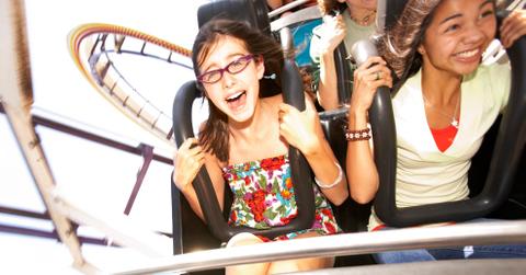People riding on roller coaster