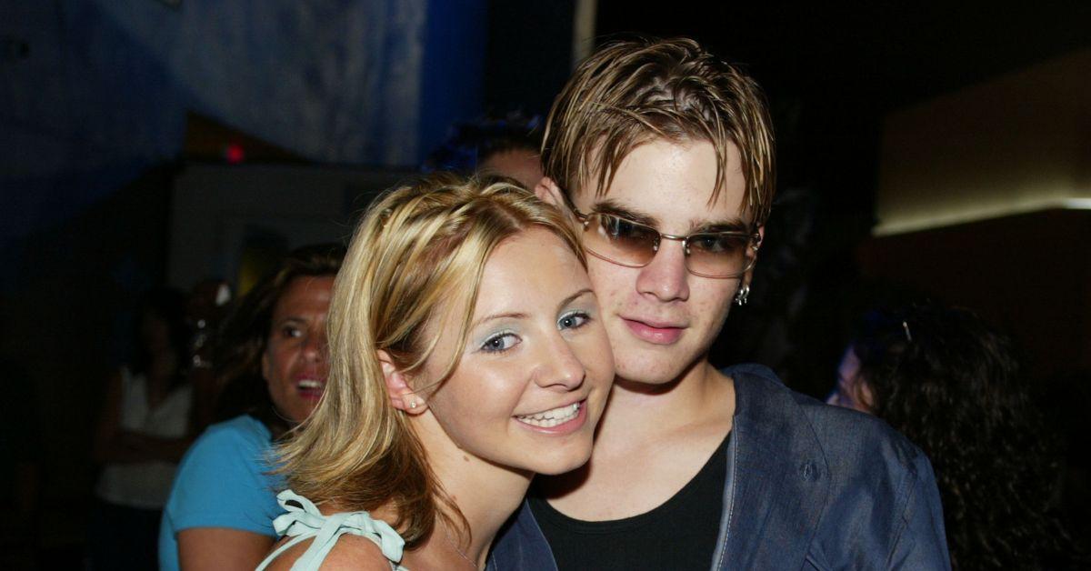 Beverley Mitchell and David Gallagher smiling at a WB event in 2002.