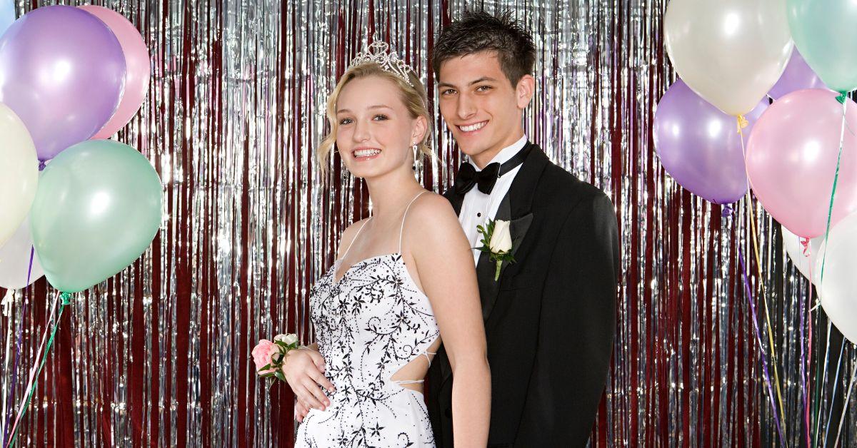 A couple taking a picture at prom