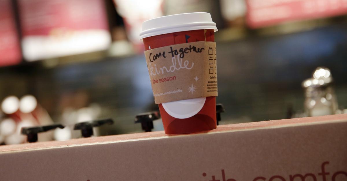 A Starbucks drink cup sitting on a counter.