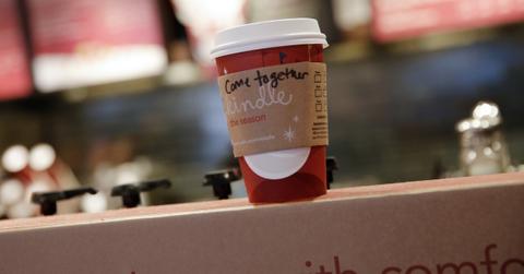 A Starbucks drink cup sitting on a counter.