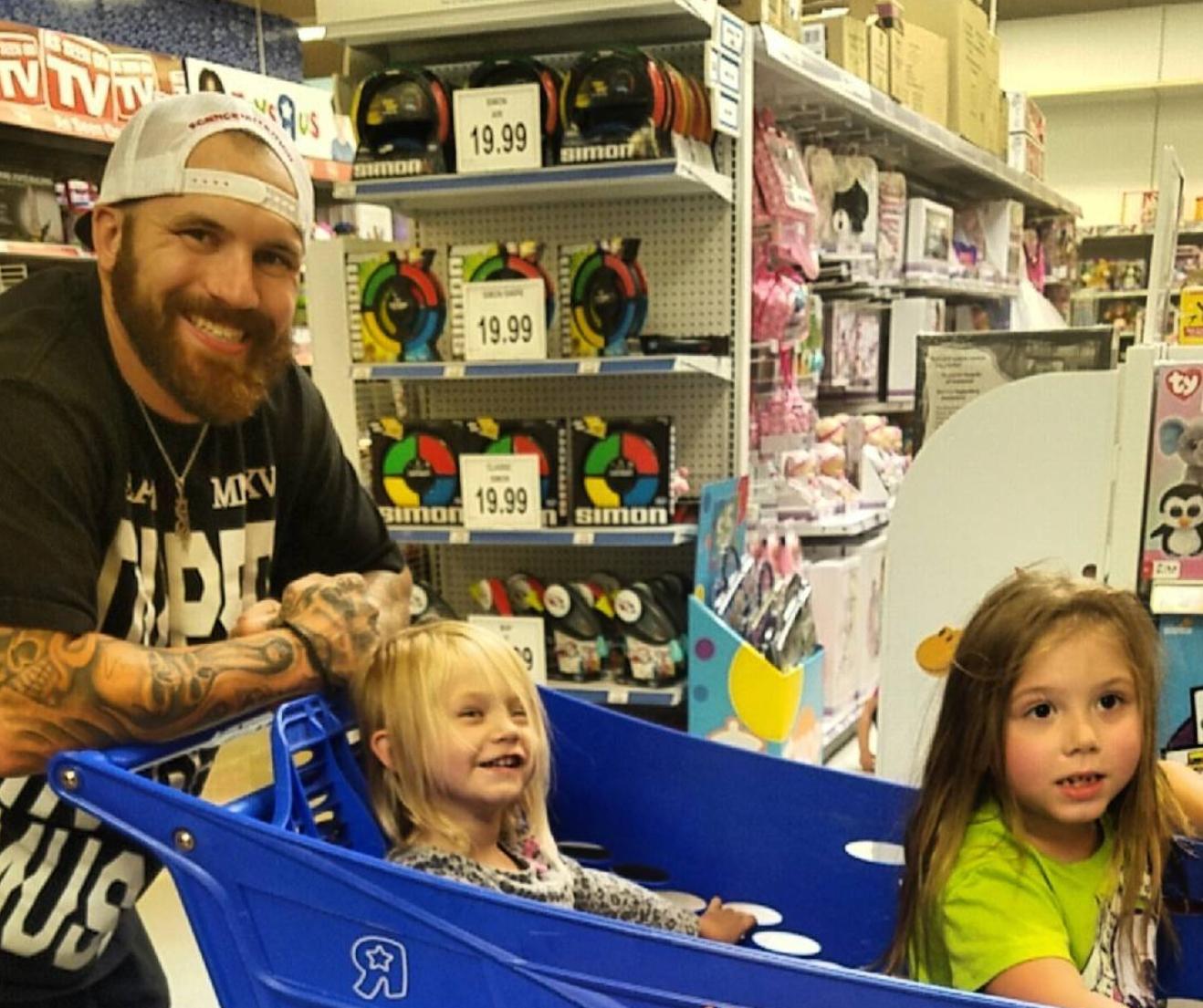 Adam Lind shopping at Toys' R Us with two of his daughters.