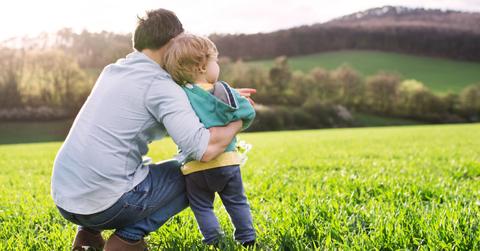 father with his toddler son outside in spring nature copy space picture id