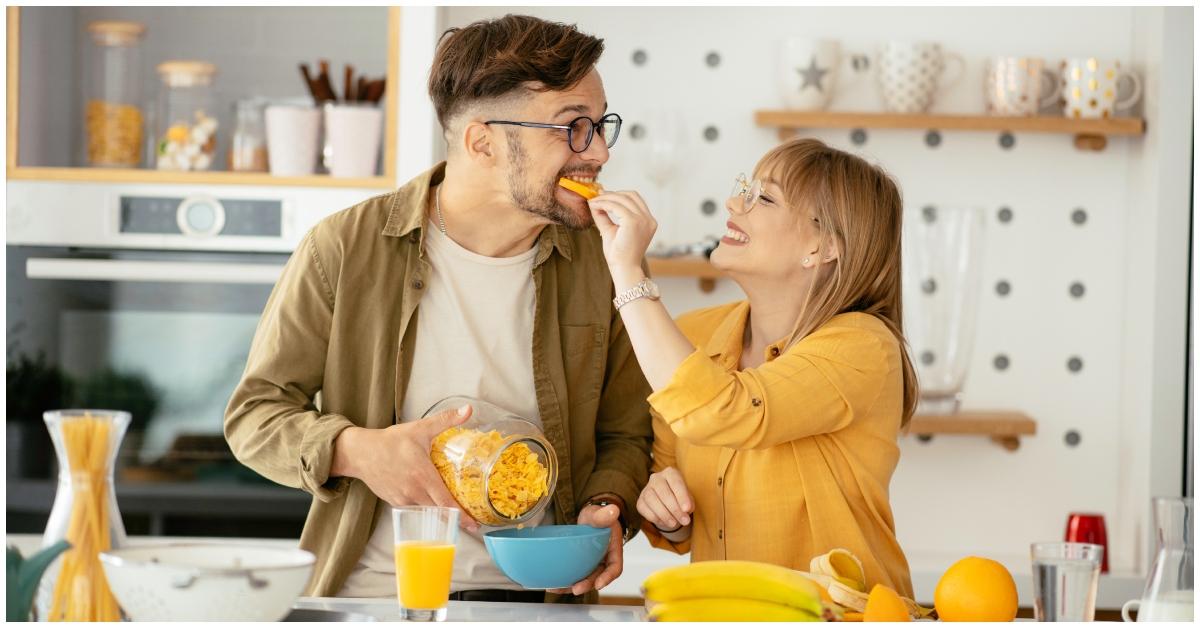 (l-r): A woman feeding her partner an orange