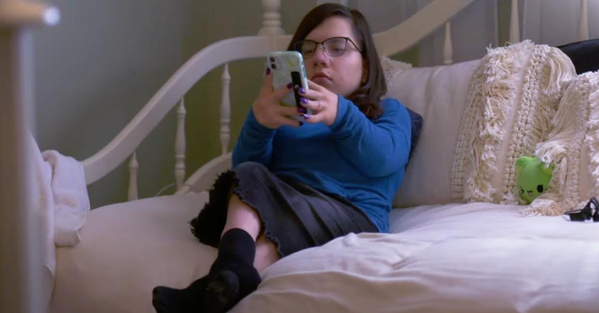 Natalia Grace on her cell phone, in a bedroom