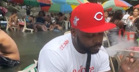 Marcus Vick smoking near a pool.