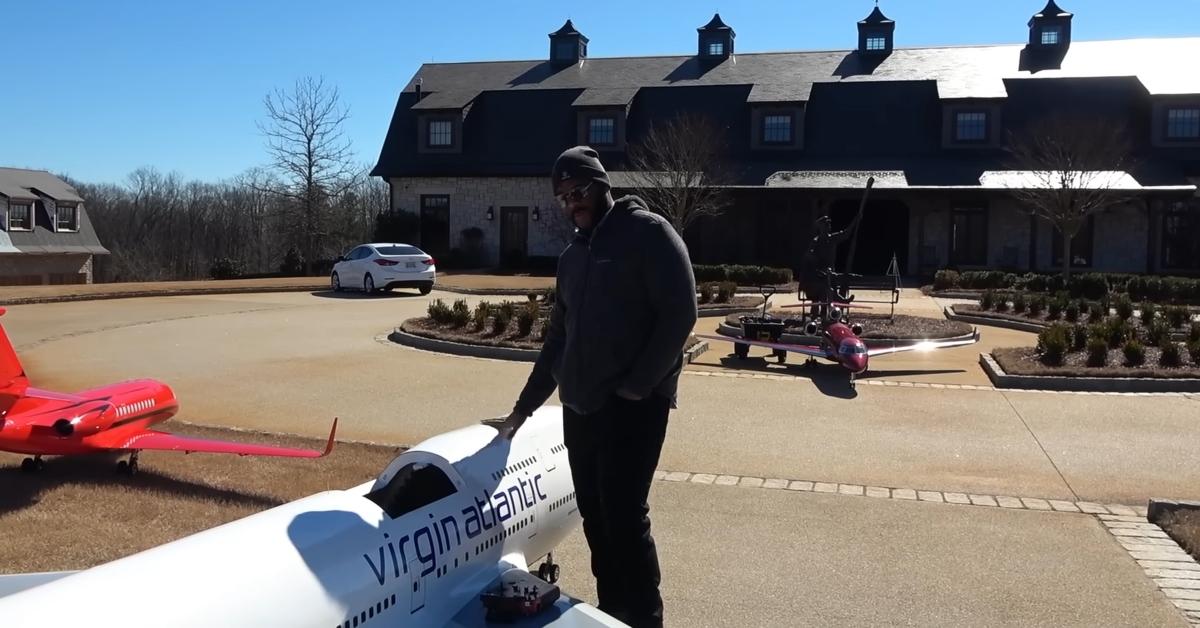 Tyler Perry stands next to one of his huge RC planes