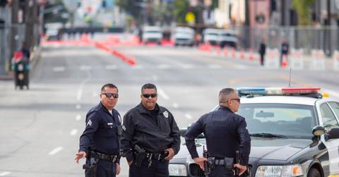 Police officers stand outside of the Oscars red carpet in the road