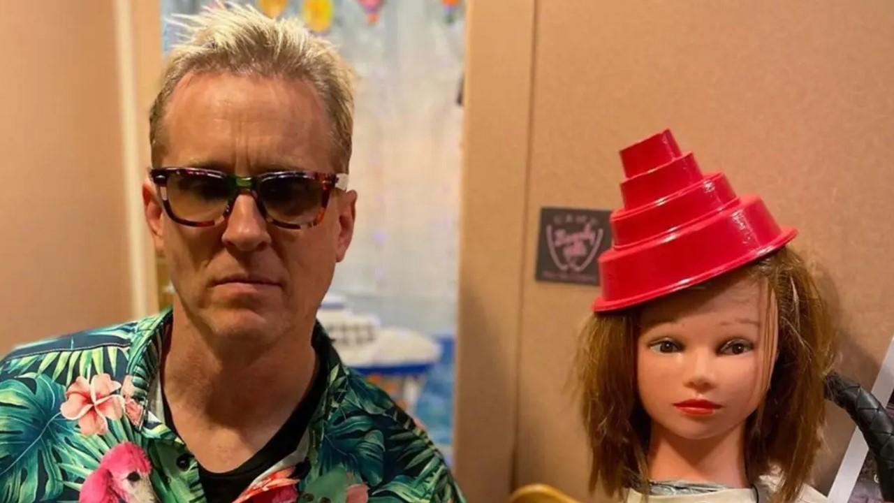 Josh Freese next to manikin wearing a red hat