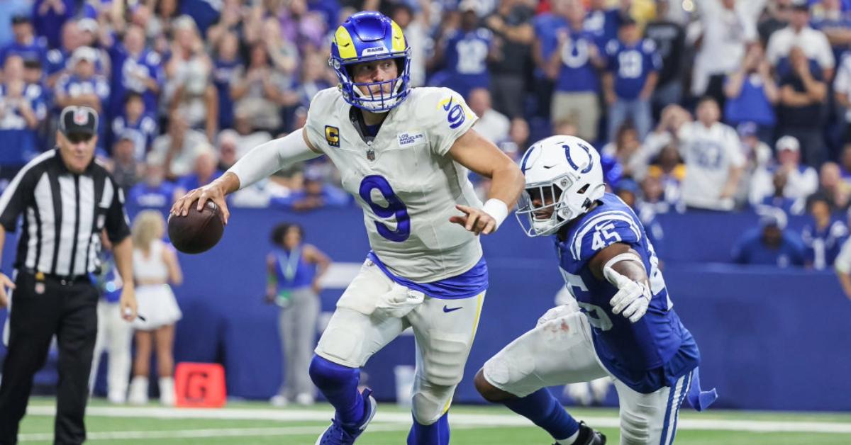 Matthew Stafford #9 of the Los Angeles Rams scrambles with the ball as E.J. Speed #45 of the Indianapolis Colts applies pressure at Lucas Oil Stadium on October 1, 2023 in Indianapolis, Indiana. 