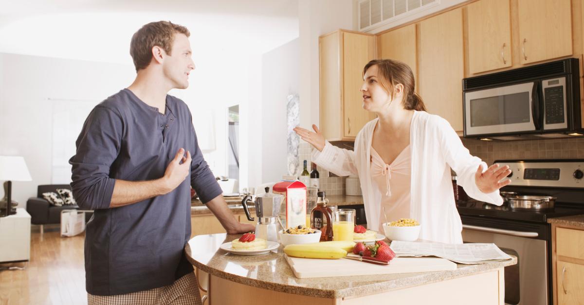 A couple argues in their kitchen.